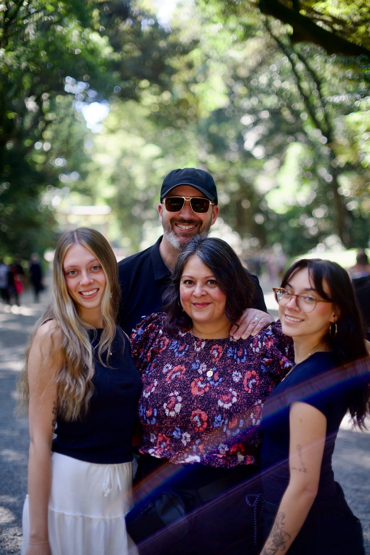 A family of four on the tree-lined approach to Meiji Jingu