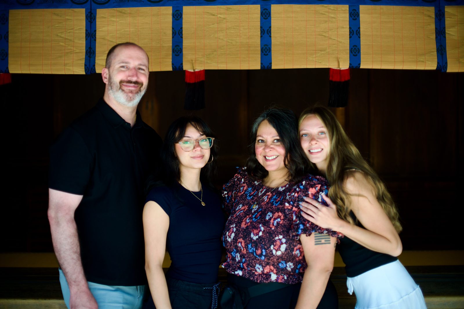 A family of four standing together at Meiji Jingu